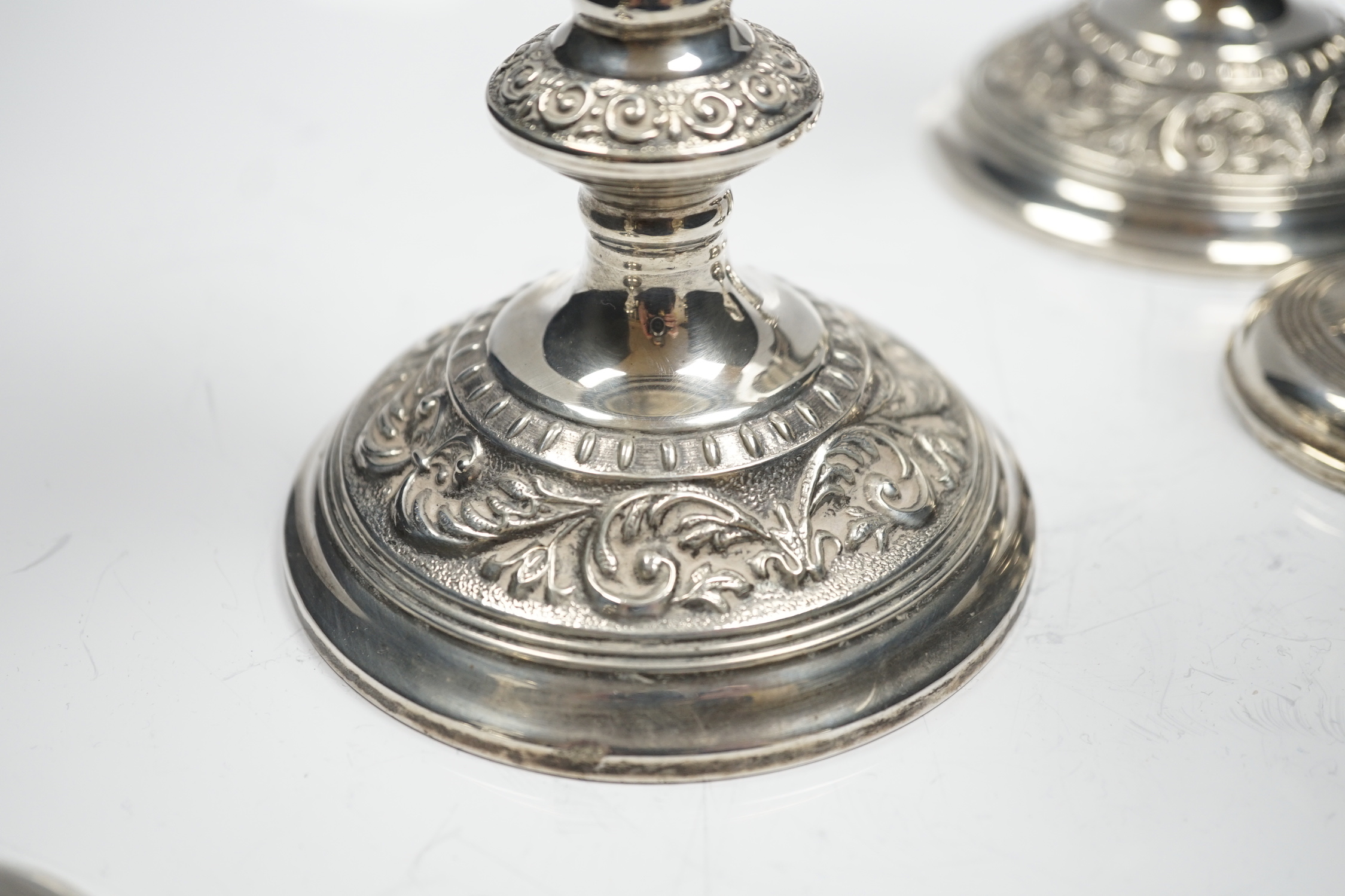 A modern pair of silver mounted candlesticks, Broadway & Co, Birmingham, 1991, 22.23cm and a pair of silver mounted dwarf candlesticks.